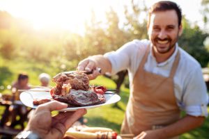man grilling meat for catering event